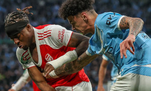 Soccer players from Manchester City and Arsenal in action