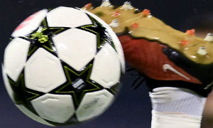 A soccer player kicks the UEFA Champions League ball
